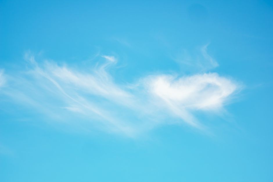 Wisps of high cirrus cloud drawn across a clear blue sky.